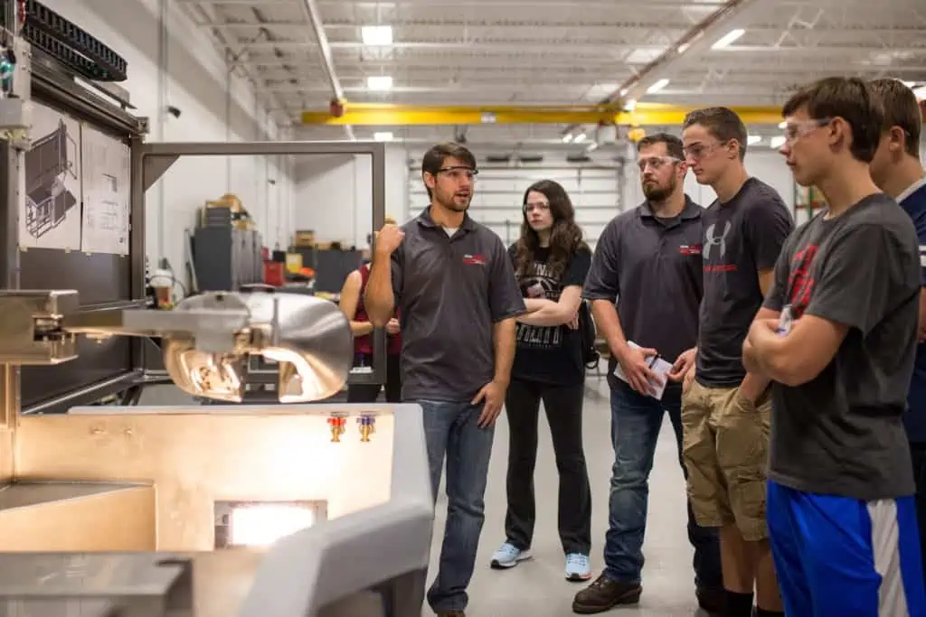 Astro Employee giving a demonstration to students during National Manufacturing Day