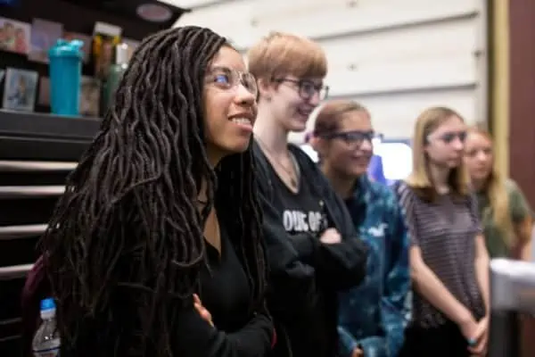 Students smiling during presentation at Astro's National Manufacturing Day event