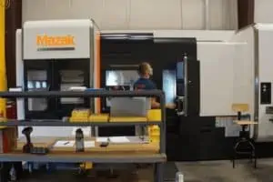 Astro Employee Operating CNC Machine