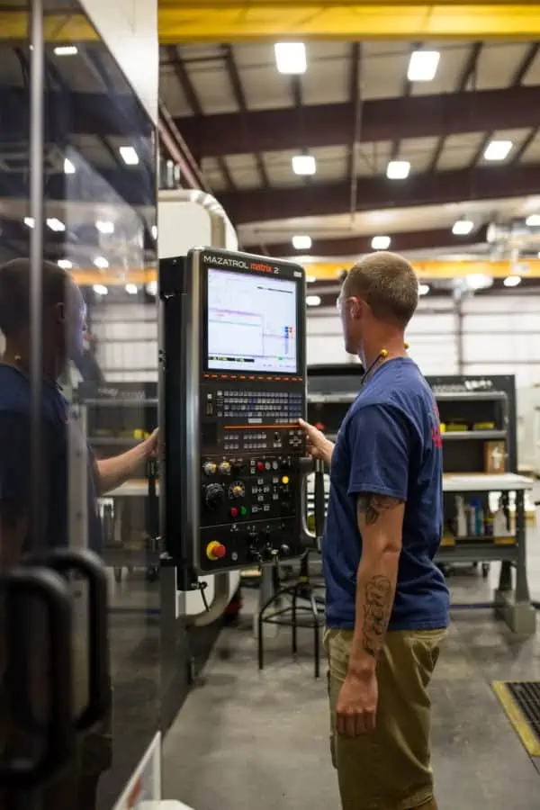 Astro employee Tom L. operating a CNC machine Astro employee Tom L. operating a CNC machine